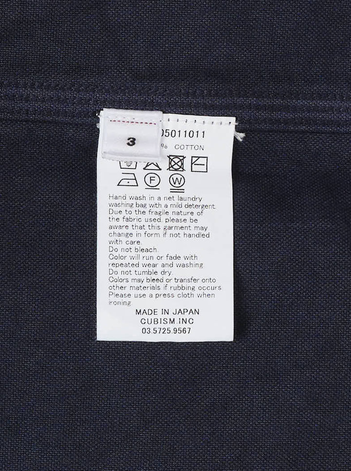 visvim Larrikan long sleeve shirt in navy with two button-flap chest pockets and dark buttons, shown from the front - view 3