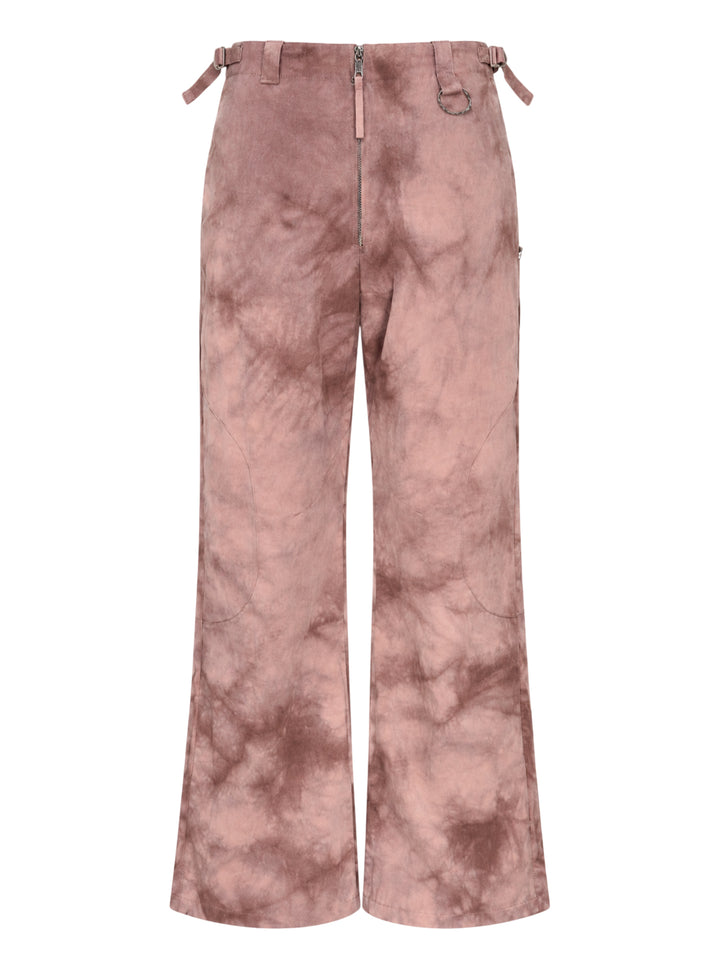 Dusty rose and brown tie-dye wide-leg trousers with a zip front, waist buckle adjusters and curved knee panel seams