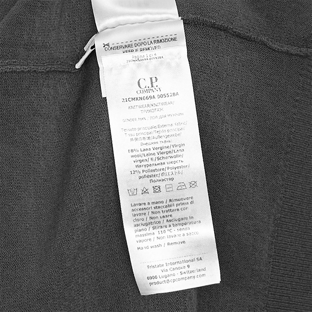 C.P. Company Extrafine Merino Wool Lens Crewneck Sweater in olive green, back view showing sleeve utility pocket and circular lens badge