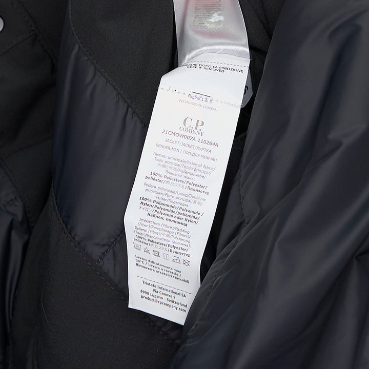 C.P. Company Pro-Tek Primaloft Silver Lens Jacket in dark grey, front view, featuring a padded high collar, snap-button storm placket, and signature goggle lens sleeve pocket