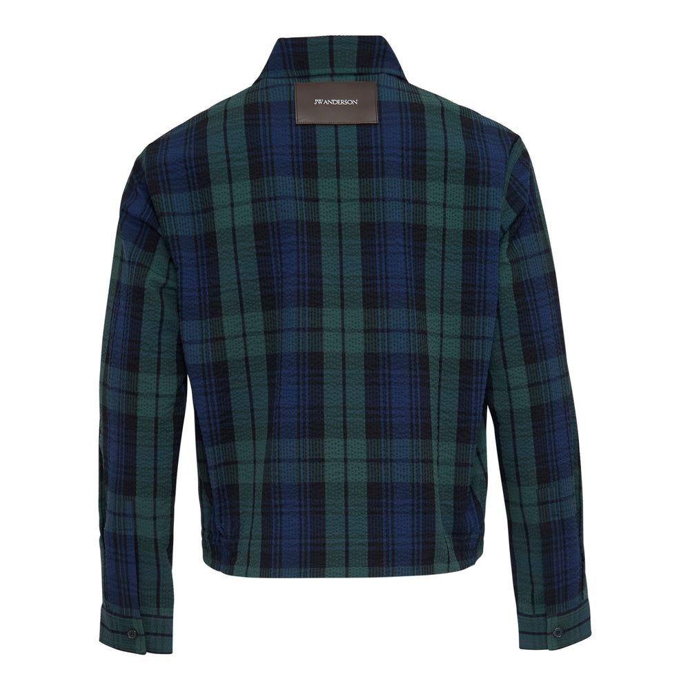 JW Anderson Front Zip Blouson in Black Watch tartan cotton seersucker, featuring a spread collar, gold-tone zip closure, and angled hip pockets