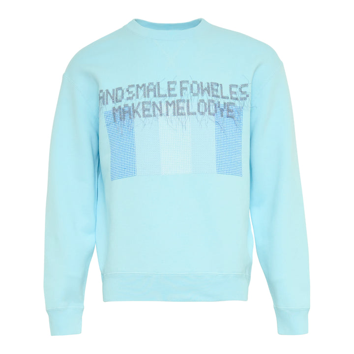 JW Anderson Small Foweles sky-blue crew-neck sweatshirt with dot-matrix embroidered Middle English text and tonal blue grid graphic on the chest, shown flat on a white background