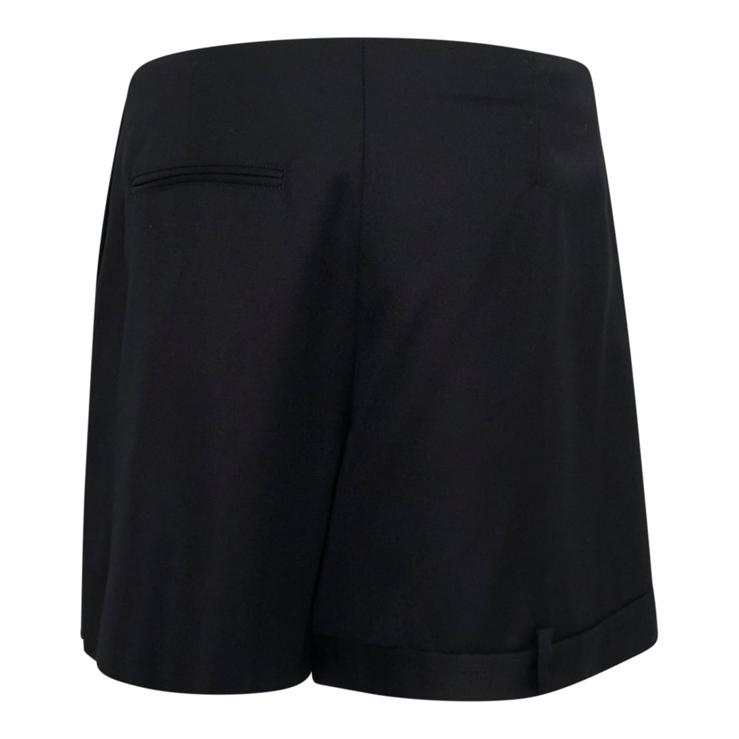 JW Anderson black Folded Wrap Shorts with asymmetric diagonal overlap front, cuffed hem with button detail, and patch pocket