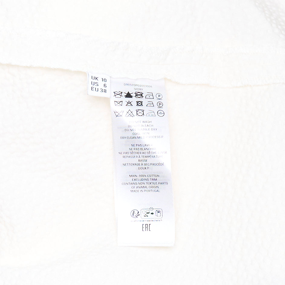 JW Anderson Cloqué Cotton Seersucker Dress in off-white, featuring a sleeveless design with a crew neckline and a full A-line skirt in textured puckered fabric