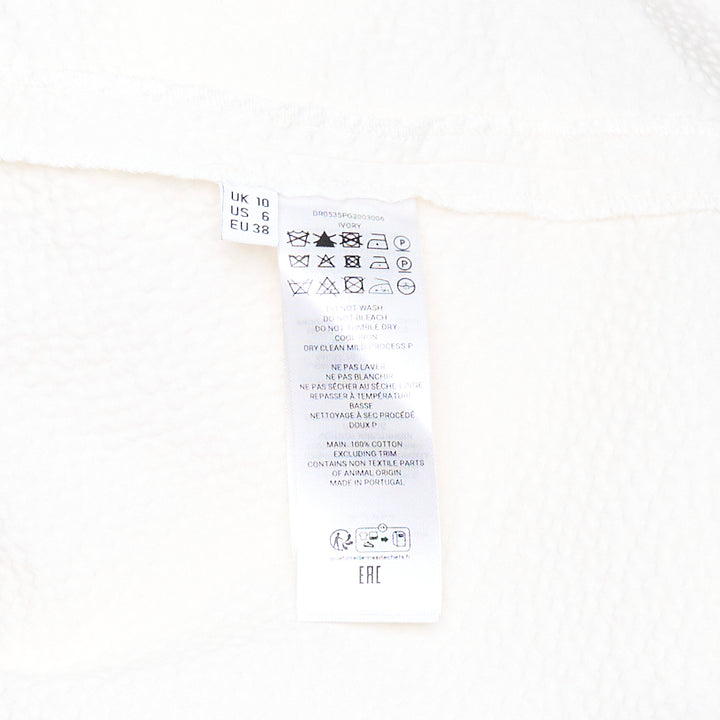 JW Anderson Cloqué Cotton Seersucker Dress in off-white, featuring a sleeveless design with a crew neckline and a full A-line skirt in textured puckered fabric