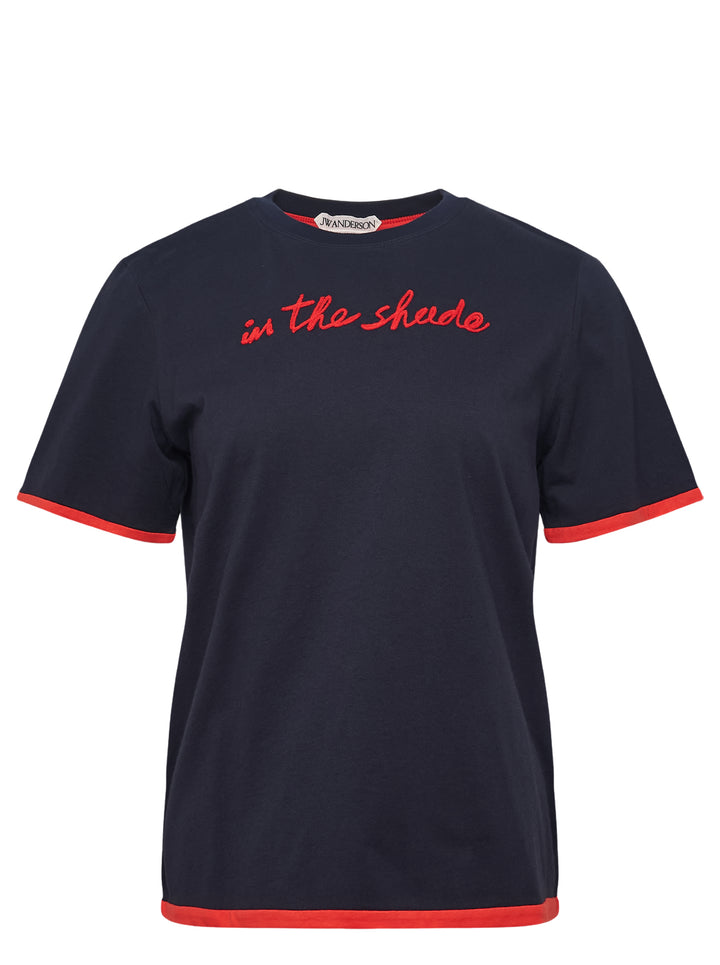 JW Anderson navy short sleeve t-shirt with red cursive 'in the shade' chest embroidery and contrast red sleeve and hem trim detailing