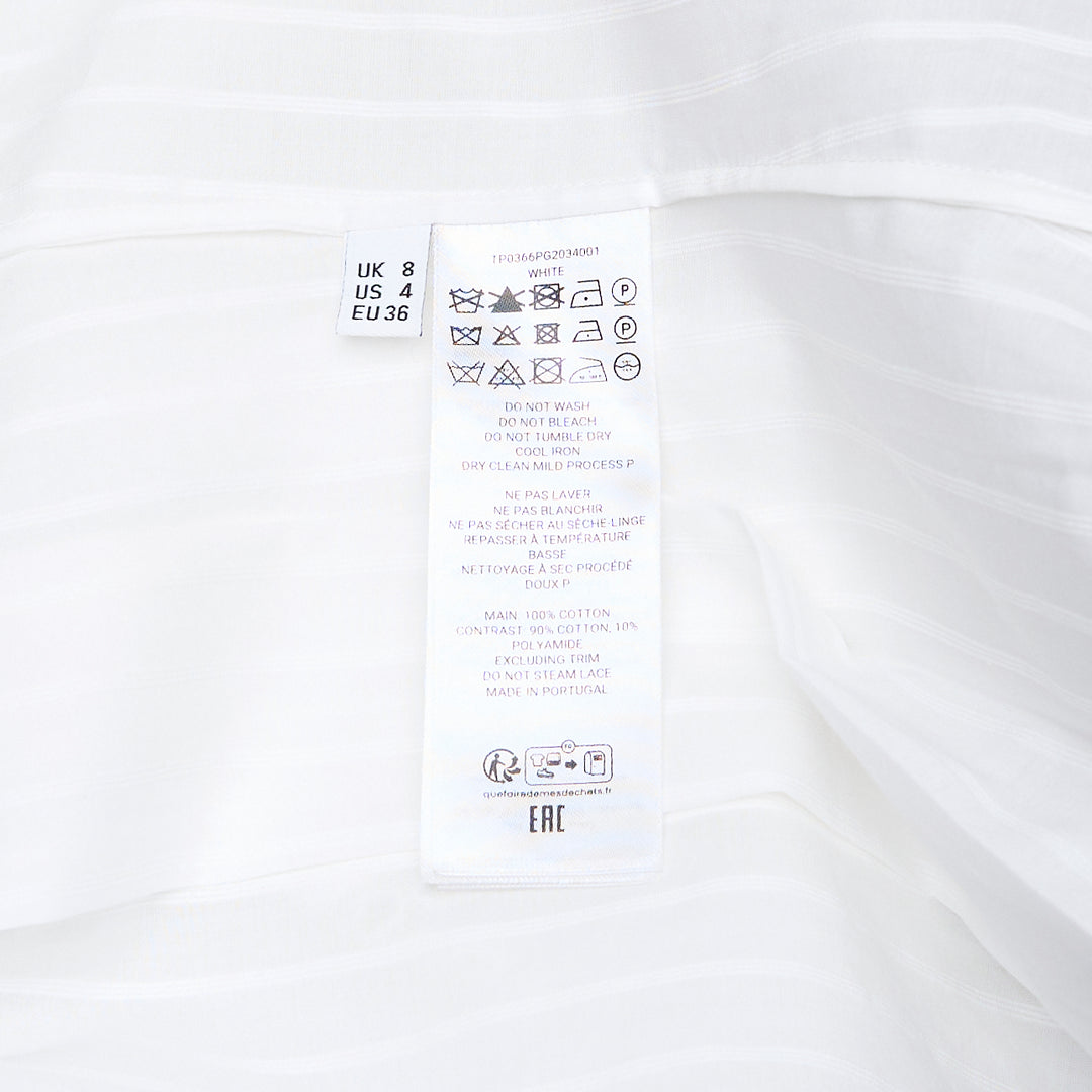 JW Anderson white woven top with dramatic draped handkerchief sleeves trimmed in broderie anglaise lace, fitted pintucked bodice, and a V-neckline with self-tie ribbon closure