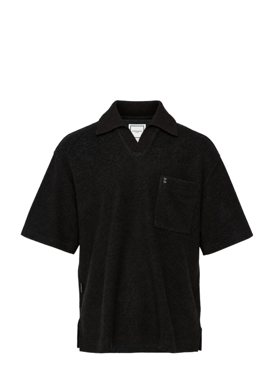 Wooyoungmi Oversized Textured Polo in black, featuring an open-placket collar, boxy short-sleeve silhouette, chest patch pocket with tonal WM monogram badge, and side hem vents