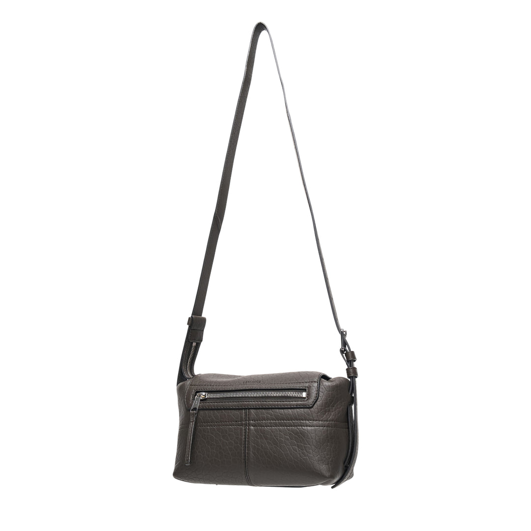 Lemaire Mini Soft Gear Bag in black pebbled leather with dual front push-lock pockets, central flap closure, and long adjustable crossbody strap with silver-tone hardware