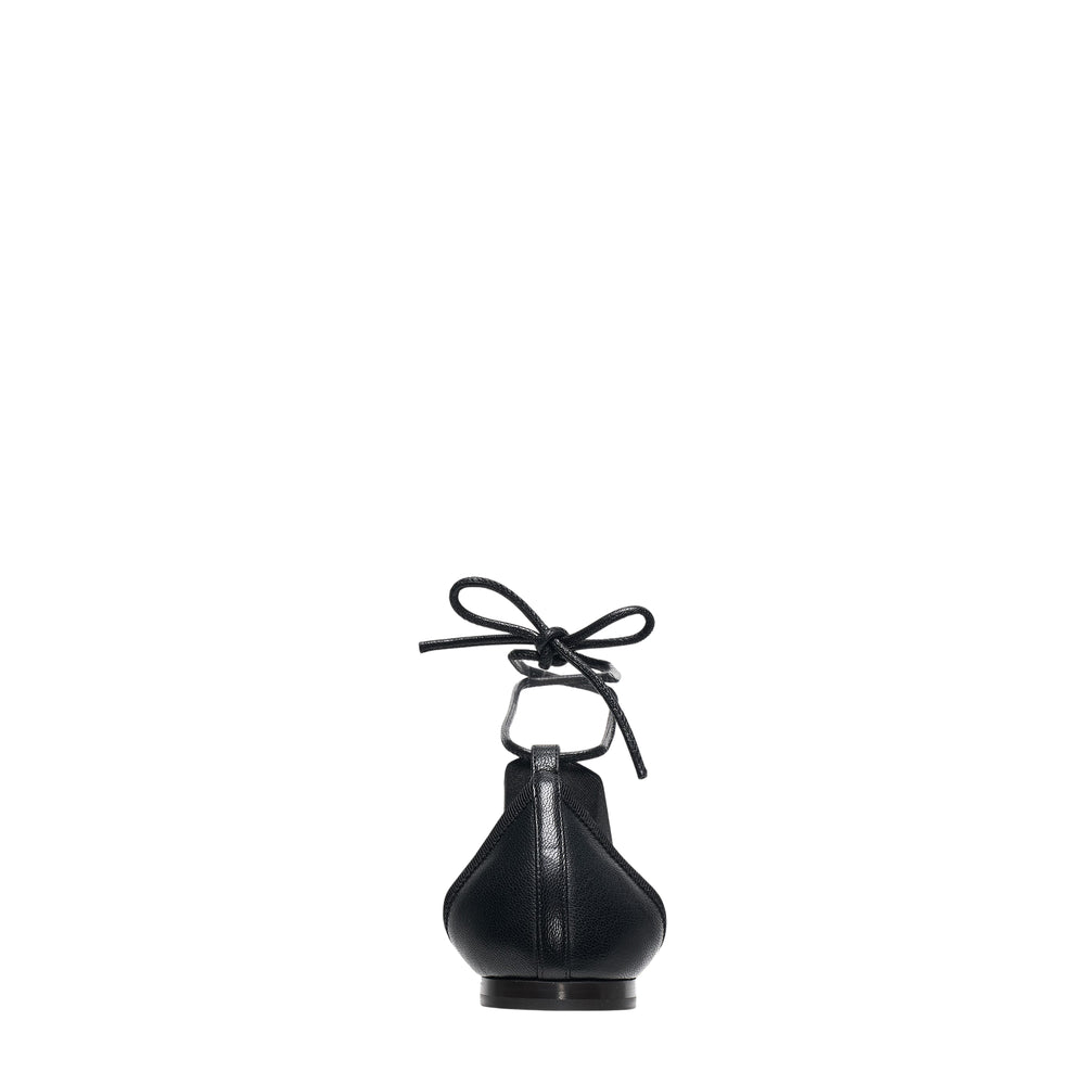 Lemaire Pedille Flat Ballerina in black pebbled goatskin with elasticated cross straps, gathered toe, and ankle-wrap cord tie, shown in profile on a white background