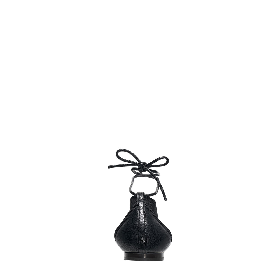 Lemaire Pedille Flat Ballerina in black pebbled goatskin with elasticated cross straps, gathered toe, and ankle-wrap cord tie, shown in profile on a white background