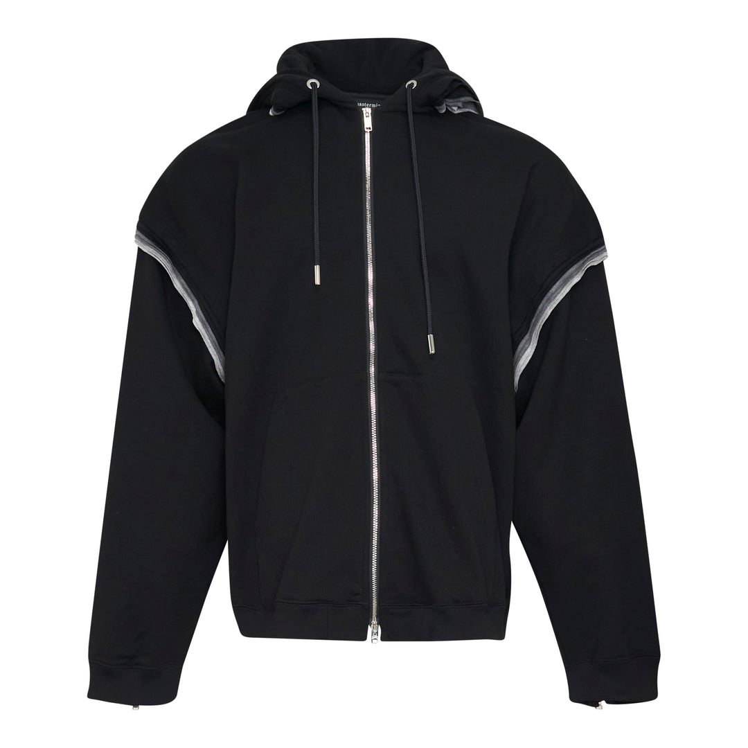 Mastermind Millefeuille Zip-Up Hoodie in black, featuring a two-way silver zip, drawstring hood, and exposed raw-edge layered detail along the shoulder and sleeve seams