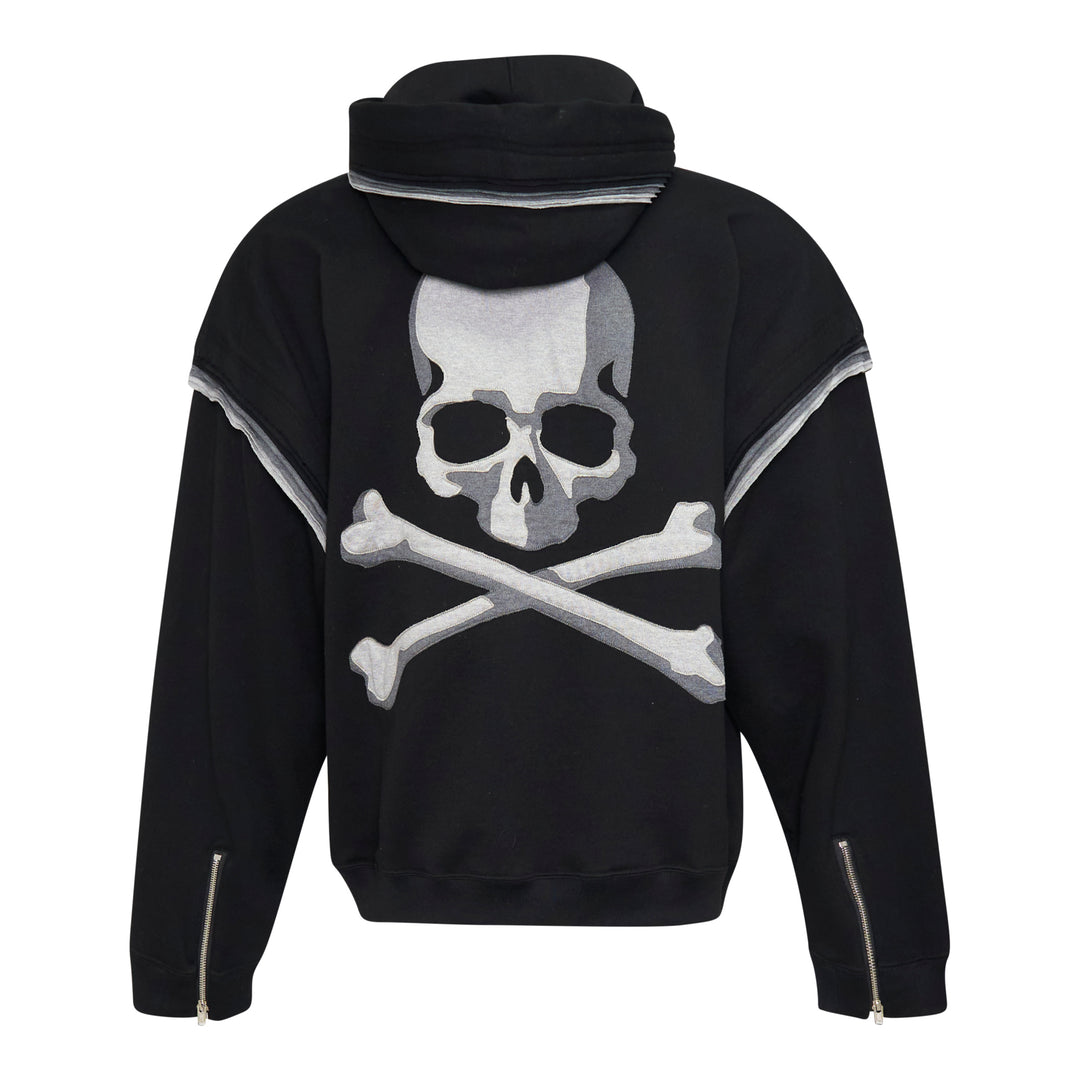 Mastermind Millefeuille Zip-Up Hoodie in black, featuring a two-way silver zip, drawstring hood, and exposed raw-edge layered detail along the shoulder and sleeve seams