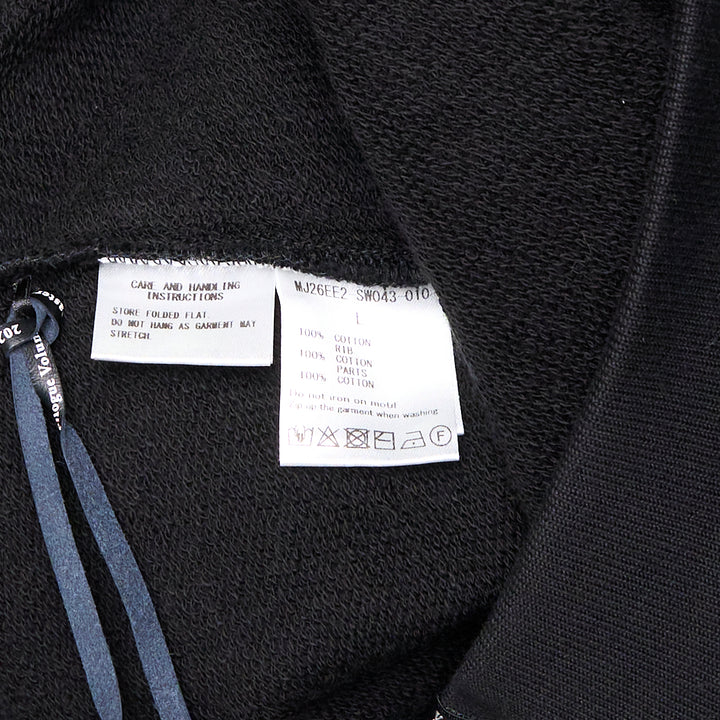 Mastermind Millefeuille Zip-Up Hoodie in black, featuring a two-way silver zip, drawstring hood, and exposed raw-edge layered detail along the shoulder and sleeve seams