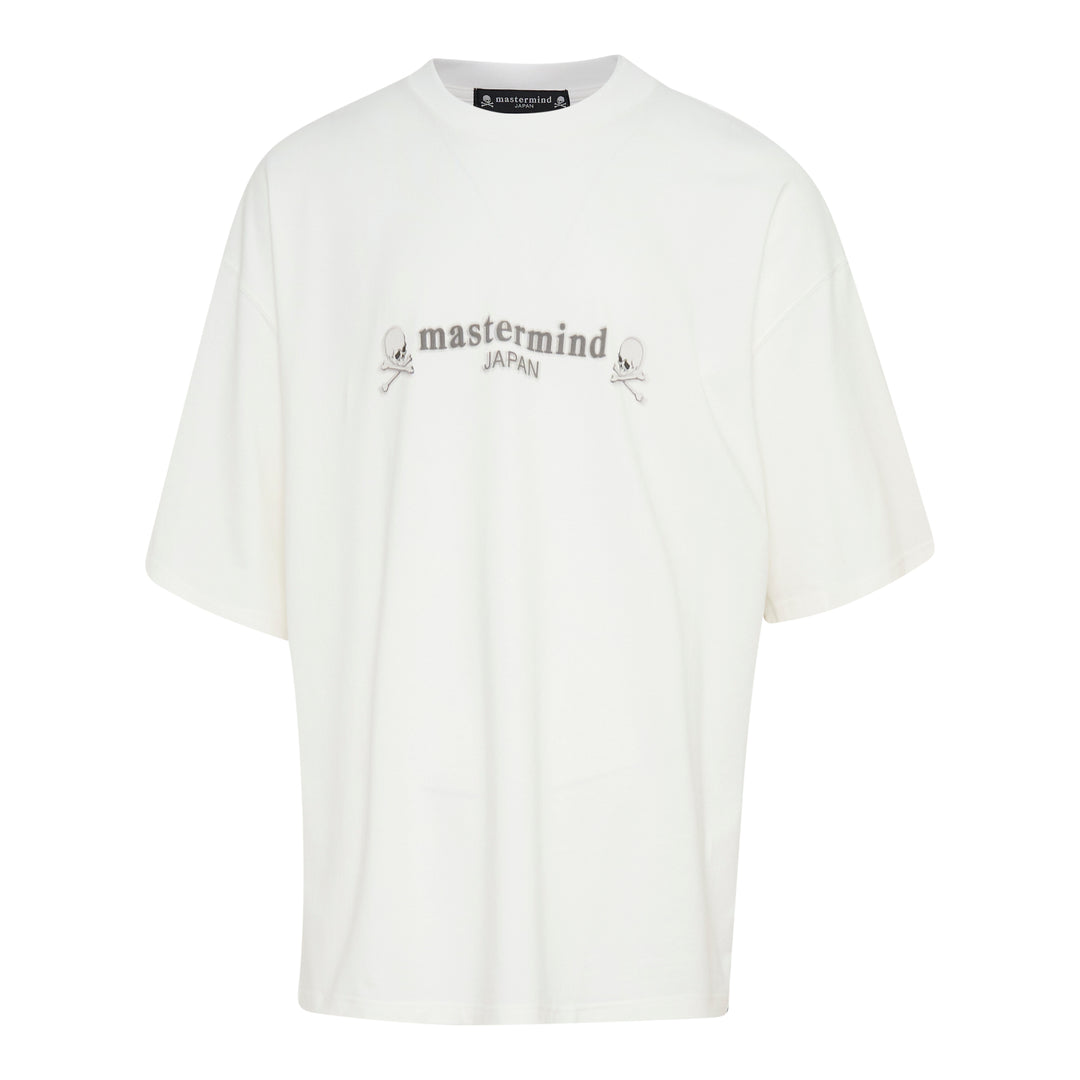 Mastermind Japan Boxy Short Sleeve Tee in off-white with tonal arched logo embroidery and skull-and-crossbones motifs at the chest