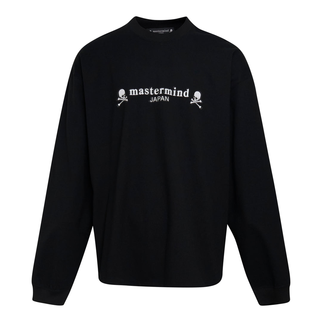 Mastermind Japan OG Boxy Long Sleeve Tee in black with embroidered arched logo and skull-and-crossbones motifs across the chest
