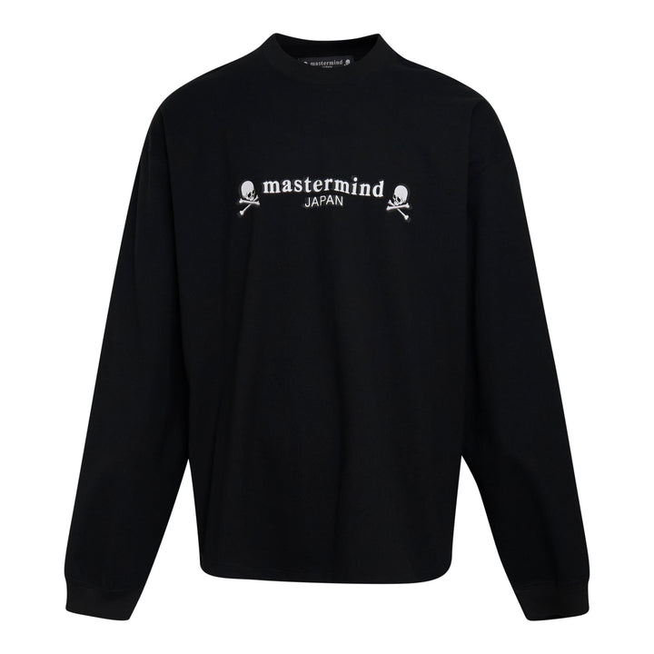 Mastermind Japan OG Boxy Long Sleeve Tee in black with embroidered arched logo and skull-and-crossbones motifs across the chest