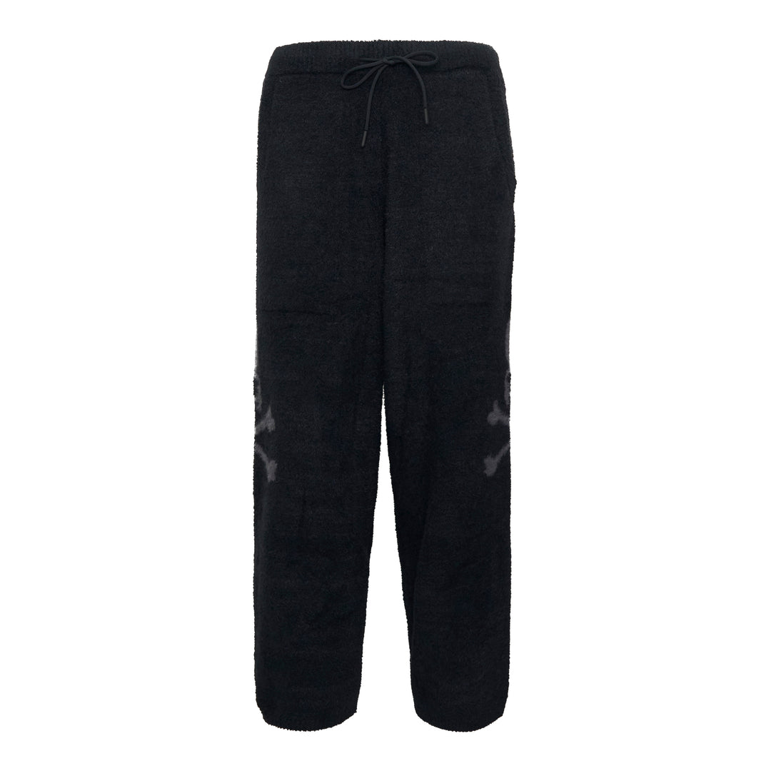 Mastermind black bouclé fleece lounge pants with tonal skull jacquard motifs at the knees and an elasticated drawstring waistband, displayed flat on a white background