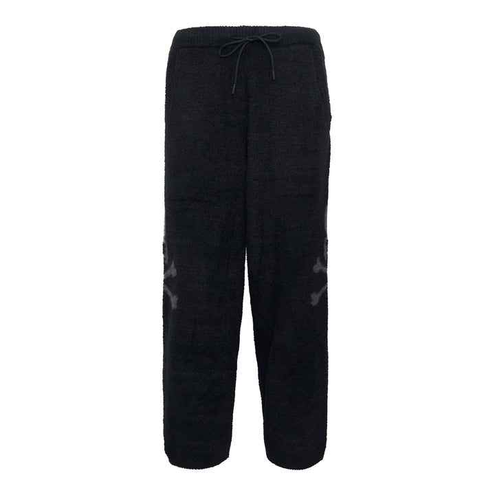 Mastermind black bouclé fleece lounge pants with tonal skull jacquard motifs at the knees and an elasticated drawstring waistband, displayed flat on a white background