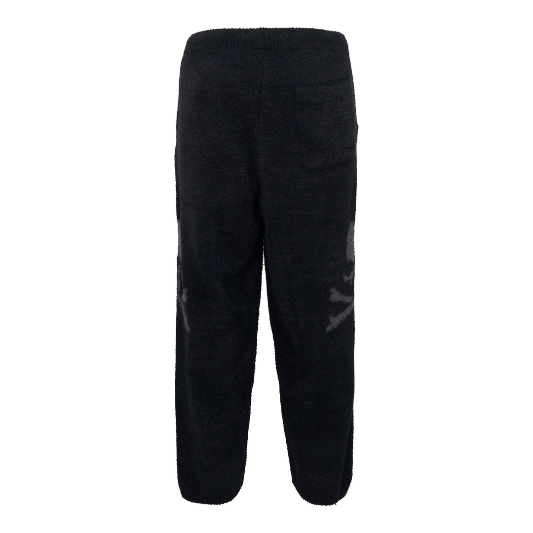 Mastermind black bouclé fleece lounge pants with tonal skull jacquard motifs at the knees and an elasticated drawstring waistband, displayed flat on a white background