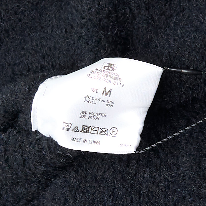 Mastermind black bouclé fleece lounge pants with tonal skull jacquard motifs at the knees and an elasticated drawstring waistband, displayed flat on a white background