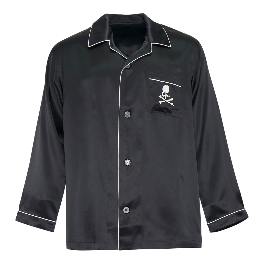 Mastermind black satin pajama set with skull and crossbones embroidery on the chest pocket, white contrast piping trim, button-front long-sleeve top, and relaxed wide-leg trousers
