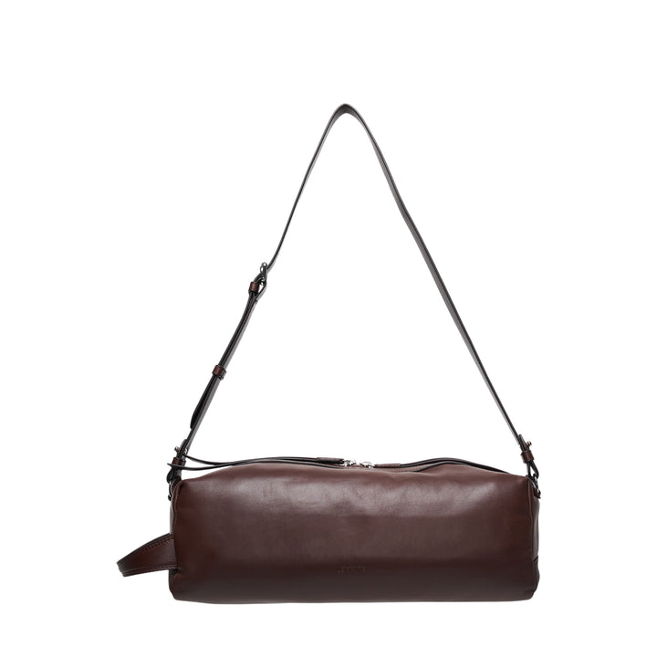 Lemaire Care Sling Bag in dark brown nappa lambskin with adjustable crossbody strap and zip closure, front view on white background