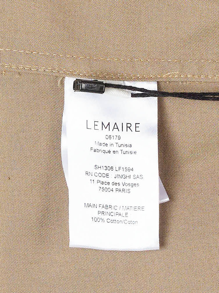 Lemaire Two Pockets Long Sleeve Shirt in tan cotton with dual patch chest pockets, dark tortoiseshell buttons, and a relaxed boxy silhouette, shown on a white background - view 3
