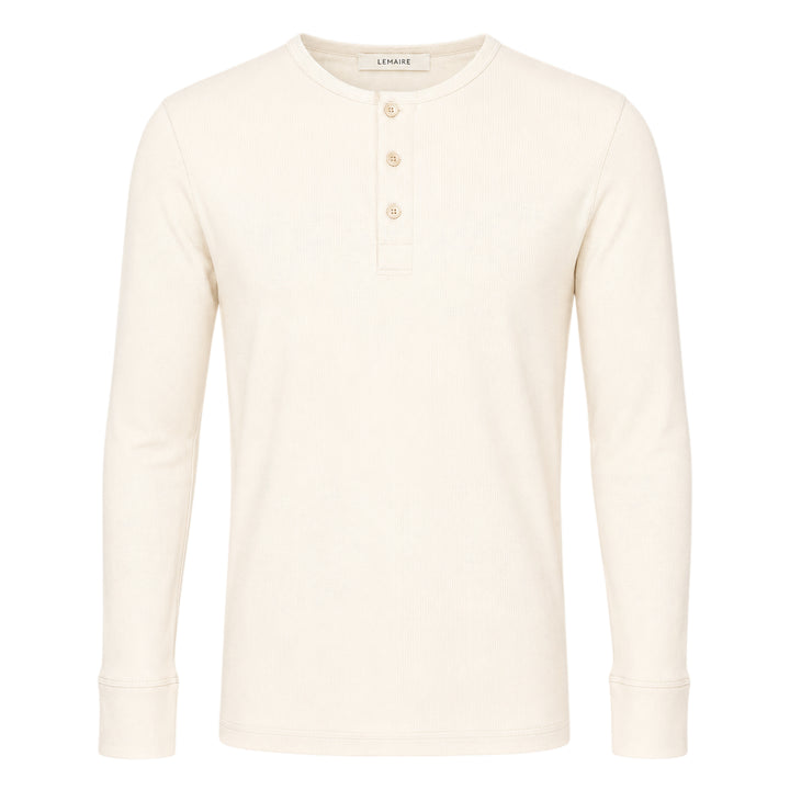 Lemaire long sleeve henley tee in off-white ribbed cotton with a three-button placket and ribbed cuffs, displayed flat on a white background