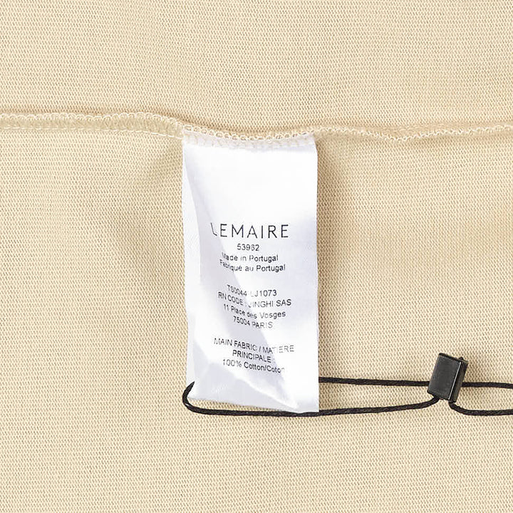 Lemaire Boxy Compact Cotton Tee in sand beige, featuring a relaxed oversized silhouette, crew neckline, and a single topstitched chest patch pocket