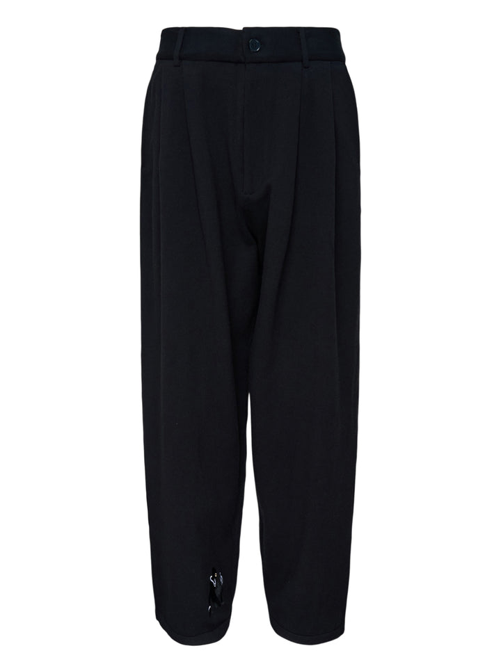 Black knitted pleated trousers with a high banded waist, button fastening and a small embroidered cat burglar motif at the hem
