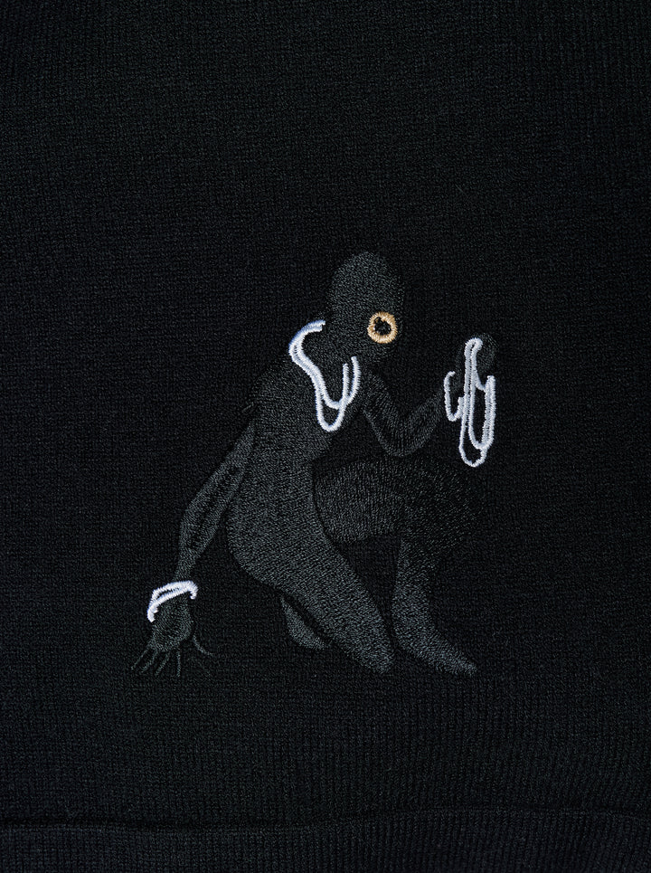 Black knitted pleated trousers with a high banded waist, button fastening and a small embroidered cat burglar motif at the hem - view 4