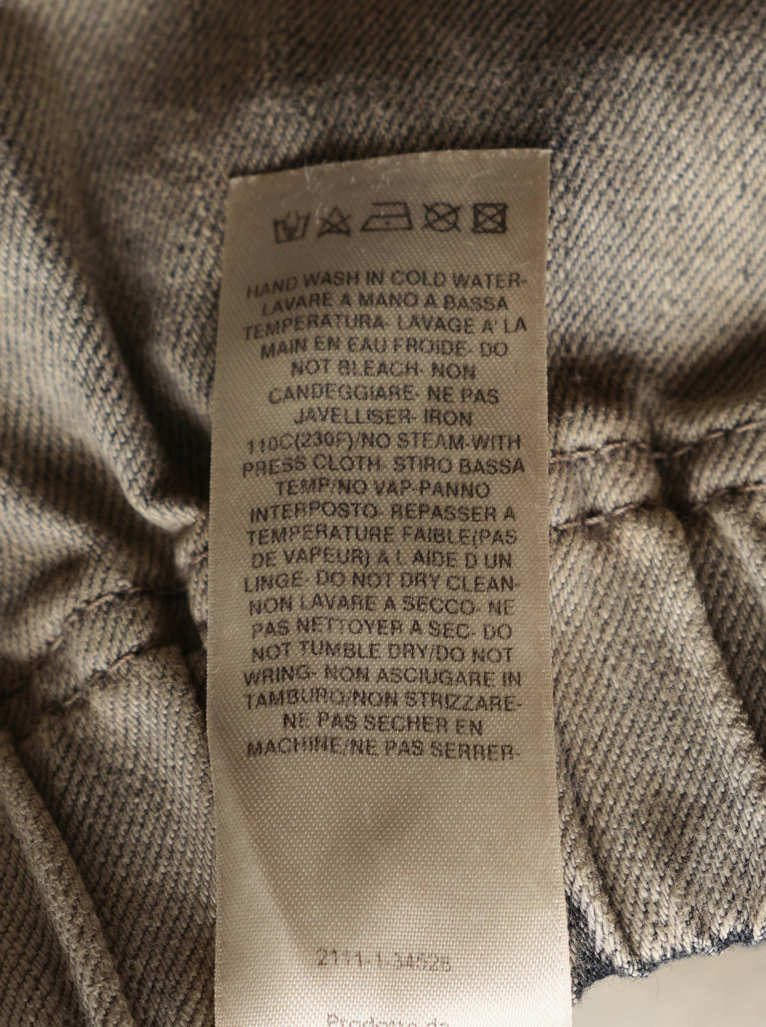Rick Owens mineral wash denim shorts with elasticated waistband and raw frayed hem in washed beige-grey tone, back view on white background - view 3
