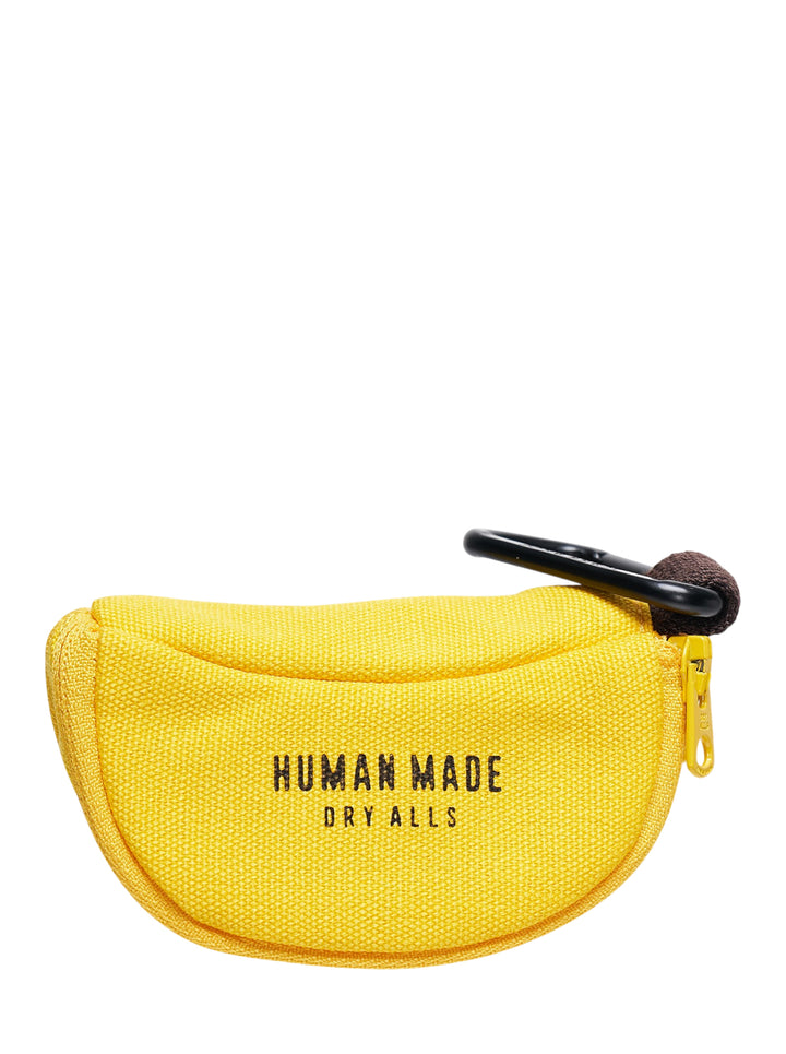 Human Made Banana Coin Pouch in yellow canvas with gold zip, brown fabric tip pull, black carabiner clip, and Dry Alls text branding on the front