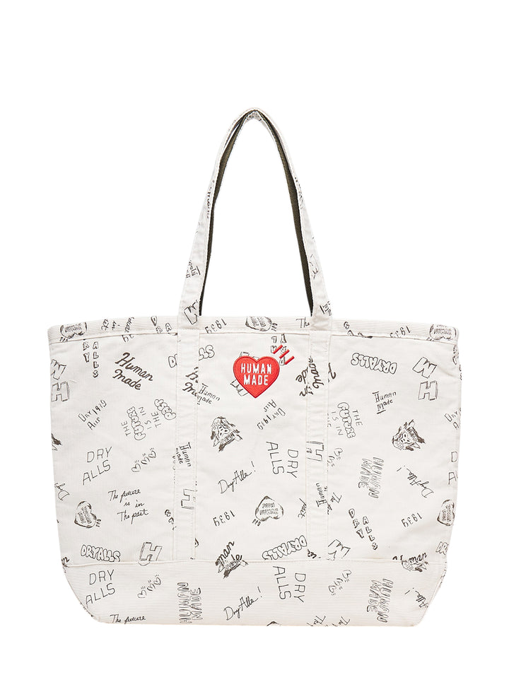 Human Made ivory corduroy tote bag with all-over hand-drawn Dry Alls graphics and an embroidered red heart logo