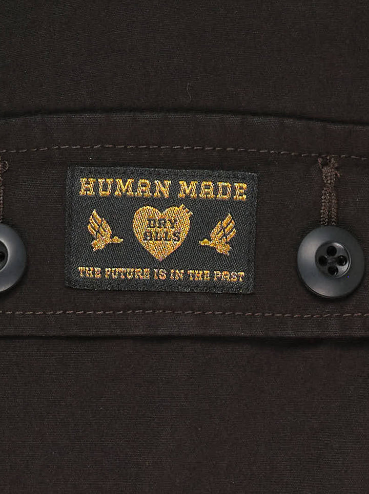 Human Made multi-pocket cargo pants in dark espresso brown, featuring a wide-leg silhouette, buckle waistband, and multiple buttoned utility cargo pockets - view 3