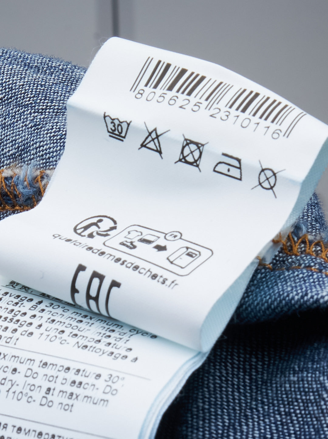 MSGM indigo denim blouse with sculptural attached bowtie bib, button-down collar, full button placket, and wide double cuffs, displayed flat on a white background - view 3