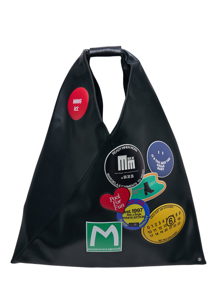 MM6 Maison Margiela Classic Japanese black triangular tote bag with colourful sticker graphics and a single top handle