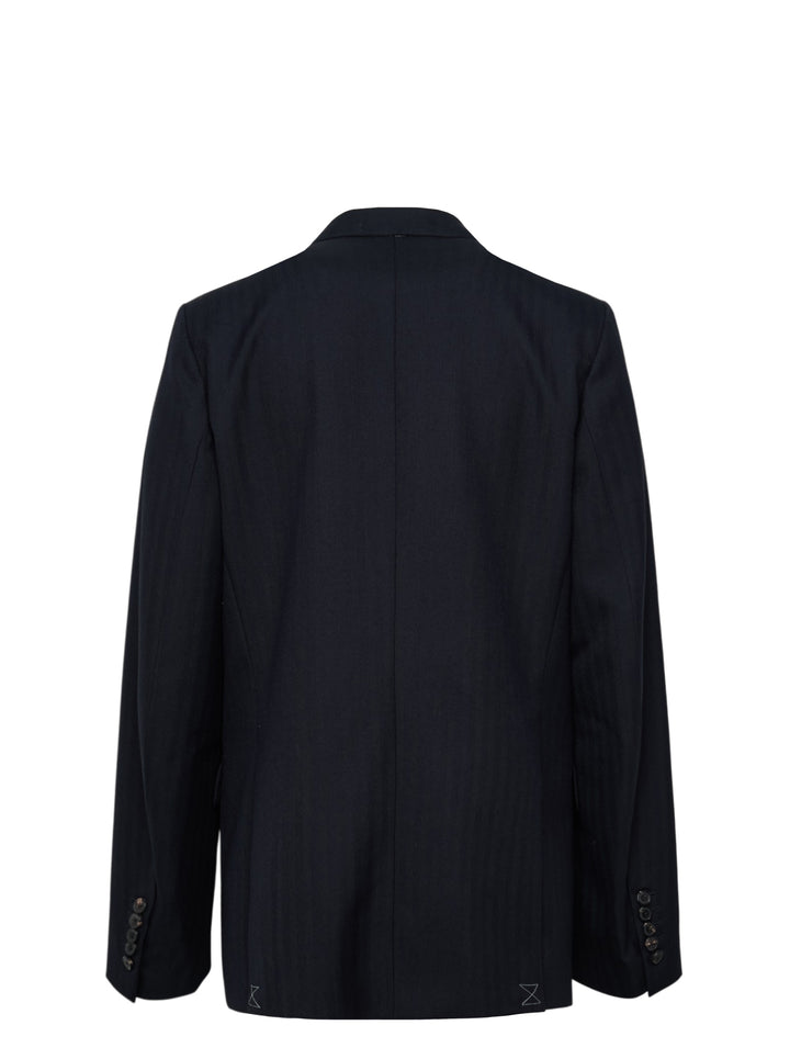 Dries Van Noten navy double-breasted blazer with peak lapels, six dark buttons, hip flap pockets, and an ornate gold embroidered brooch detail on the chest - view 2