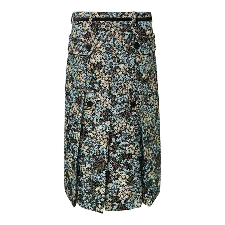 Dries Van Noten floral jacquard straight midi skirt with double-breasted button placket, flap pockets, belt loops with contrast ribbon belt, and front hem pleats, displayed flat on a white background