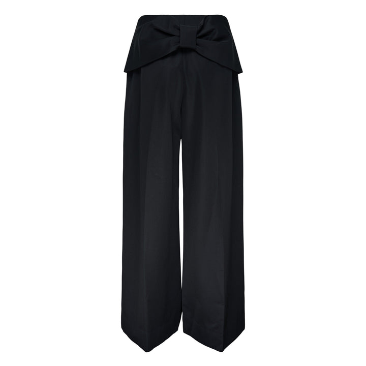 Simone Rocha Back Bow Wide Leg Trousers in black, featuring deep front pleats, a high waist, and a fluid wide-leg silhouette with a signature bow detail at the back