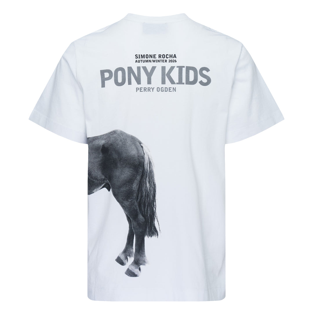 Simone Rocha white oversized short-sleeve tee featuring a black-and-white photographic print of a young boy standing with a pony, with a woven label at the inner back neck