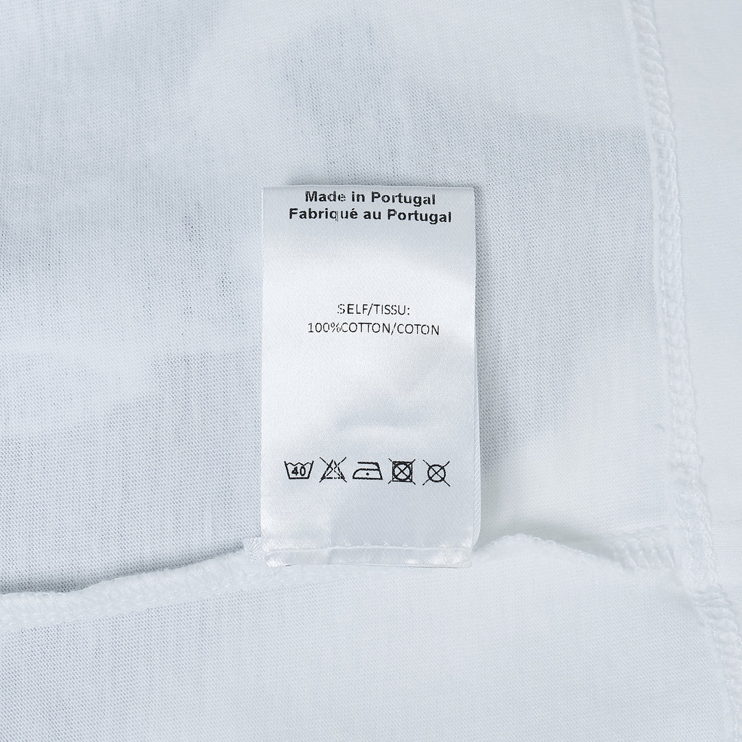 Simone Rocha white oversized short-sleeve tee featuring a black-and-white photographic print of a young boy standing with a pony, with a woven label at the inner back neck