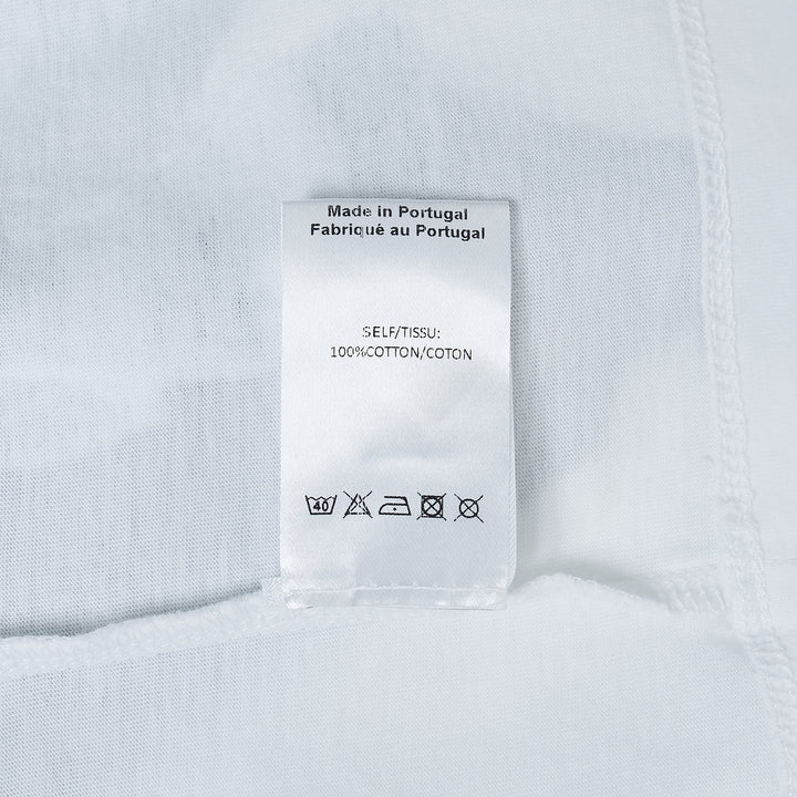 Simone Rocha white oversized short-sleeve tee featuring a black-and-white photographic print of a young boy standing with a pony, with a woven label at the inner back neck