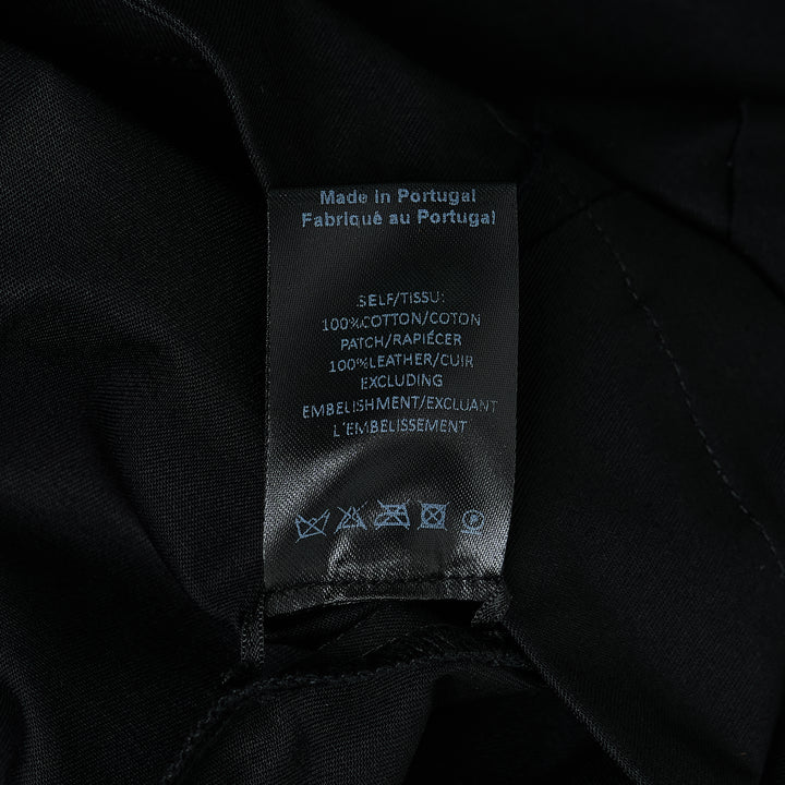 Simone Rocha black cotton twill military overshirt, front view, featuring dual flap chest pockets, tonal button-front closure, and a relaxed oversized silhouette