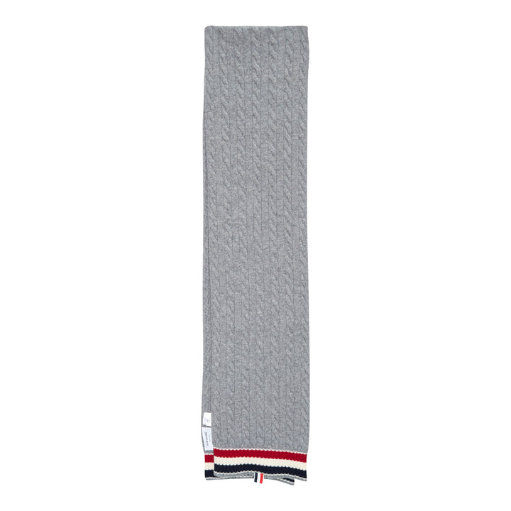 Thom Browne navy cable-knit merino wool scarf with ribbed hem featuring signature red, white, and blue stripe trim and woven brand label tab