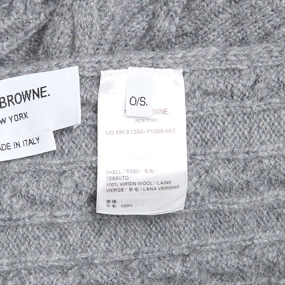 Thom Browne navy cable-knit merino wool scarf with ribbed hem featuring signature red, white, and blue stripe trim and woven brand label tab