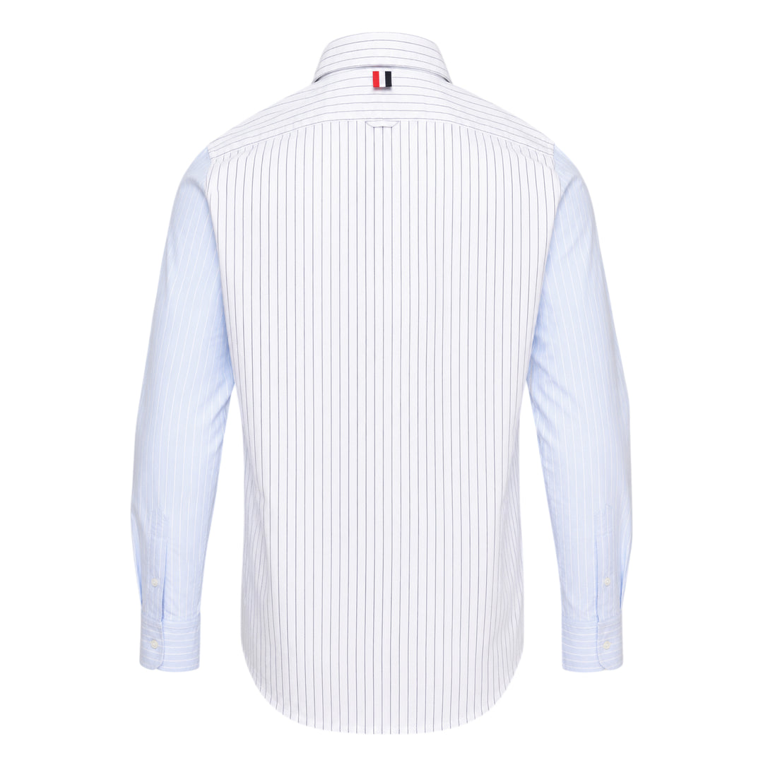 Thom Browne Straight Fit Long Sleeve Shirt in light blue pinstripe with contrast stripe sleeve panels, chest patch pocket, and woven branding label at the hem
