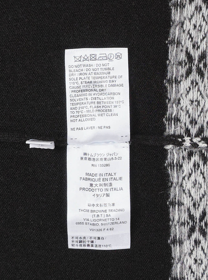 Black sleeveless turtleneck knit vest with white and grey Icelandic Fair Isle snowflake pattern across the yoke and hem - view 4