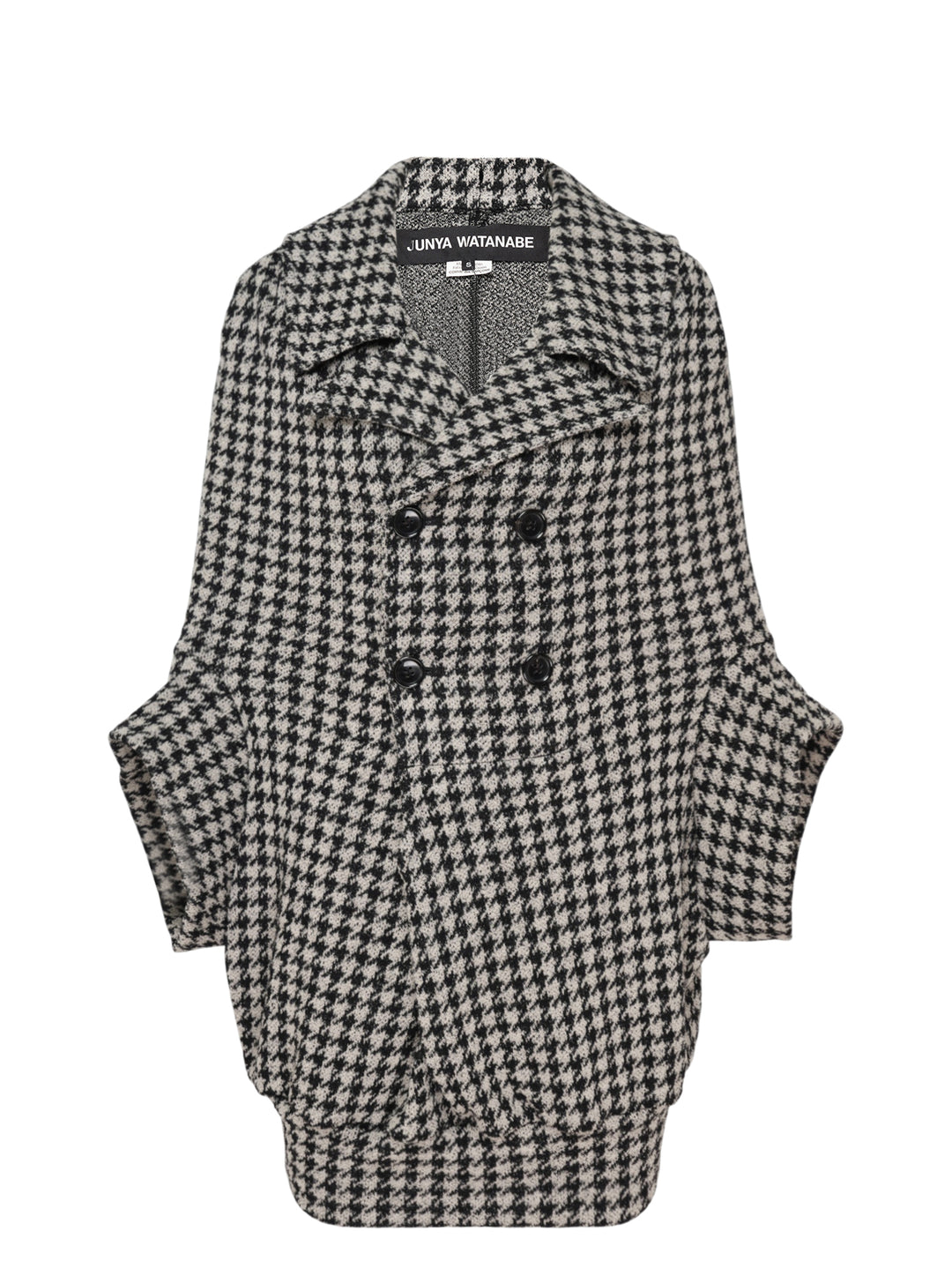 Junya Watanabe black and white houndstooth double-breasted structured coat with oversized silhouette, four black buttons, and large hip pockets, flat lay on white background